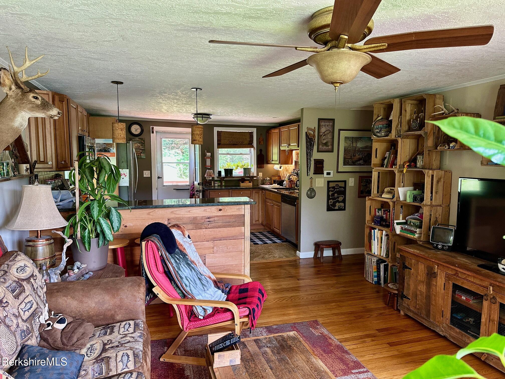 1872 North Main Road Otis, MA 01253 - Photo 5 of 33 a living room with furniture ceiling fan and a rug