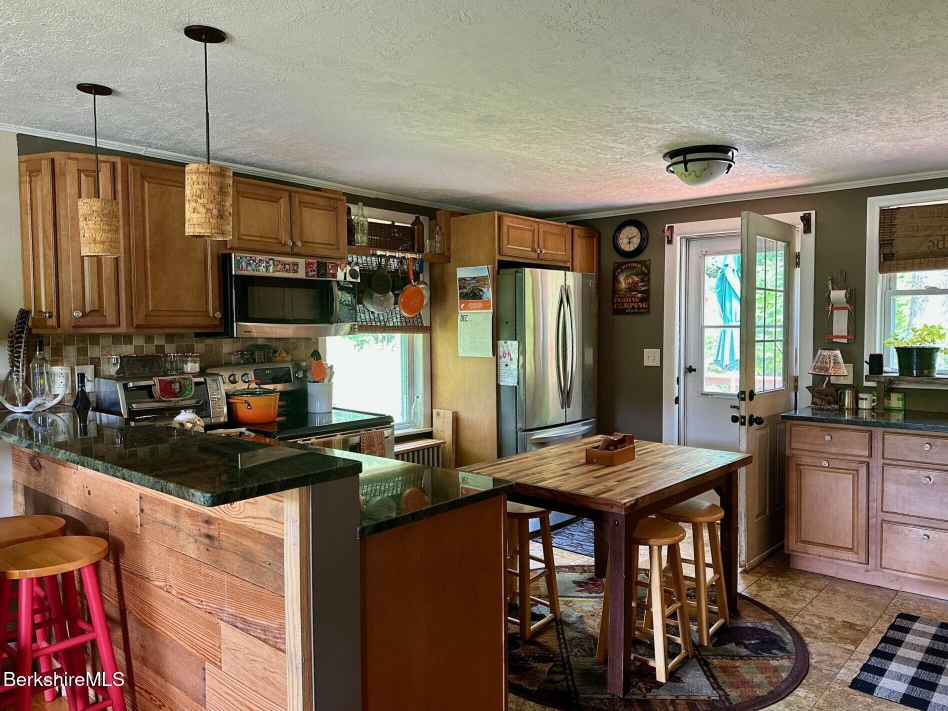 1872 North Main Road Otis, MA 01253 - Photo 6 of 33 a kitchen with stainless steel appliances granite countertop a stove a sink and a microwave