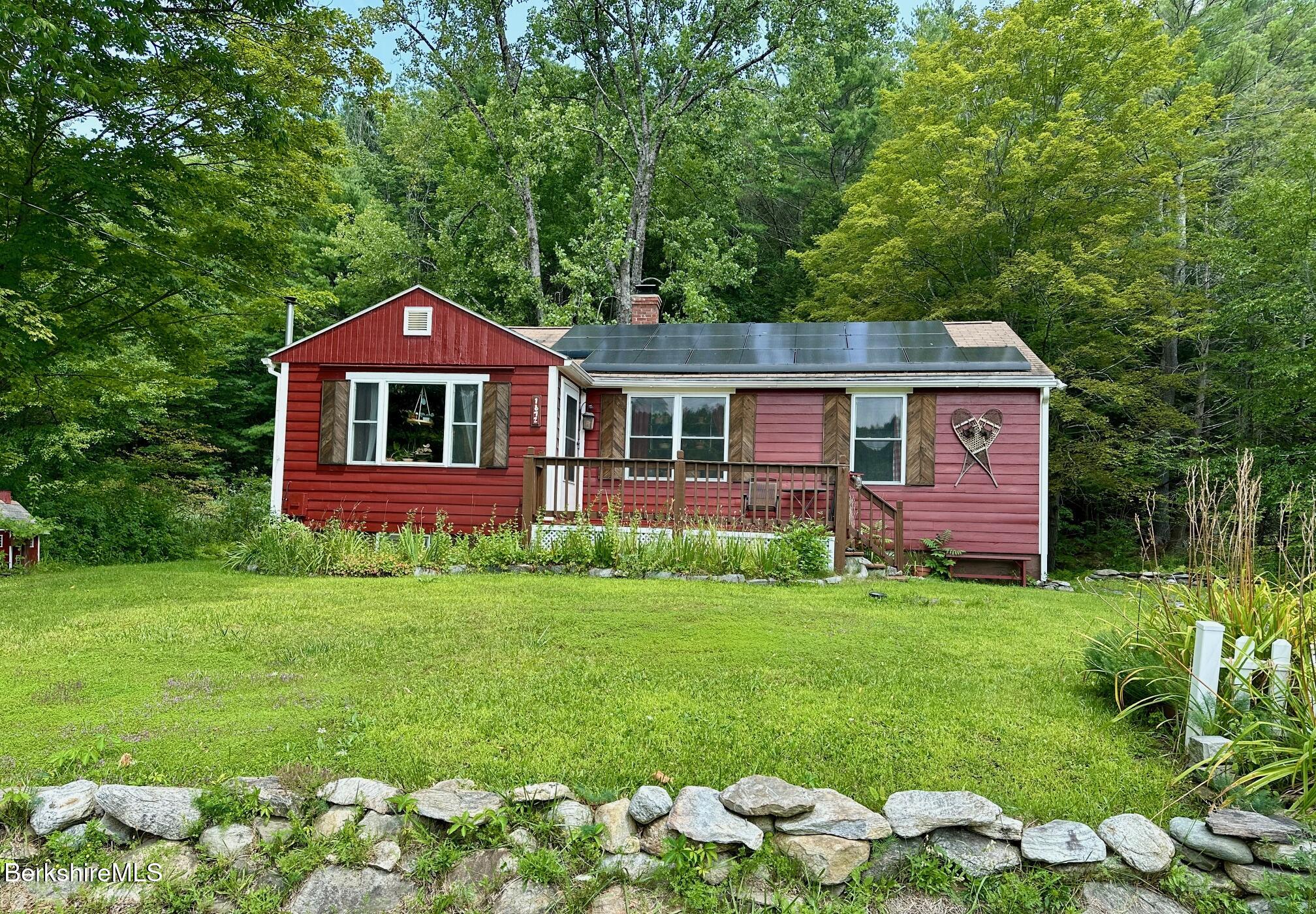 1872 North Main Road Otis, MA 01253 - Photo 7 of 33 a front view of a house with a garden