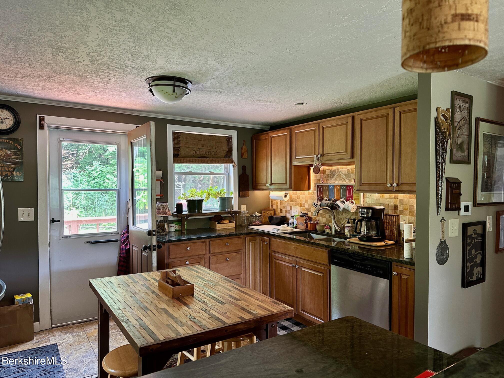 1872 North Main Road Otis, MA 01253 - Photo 9 of 33 a kitchen with a table chairs stove and refrigerator