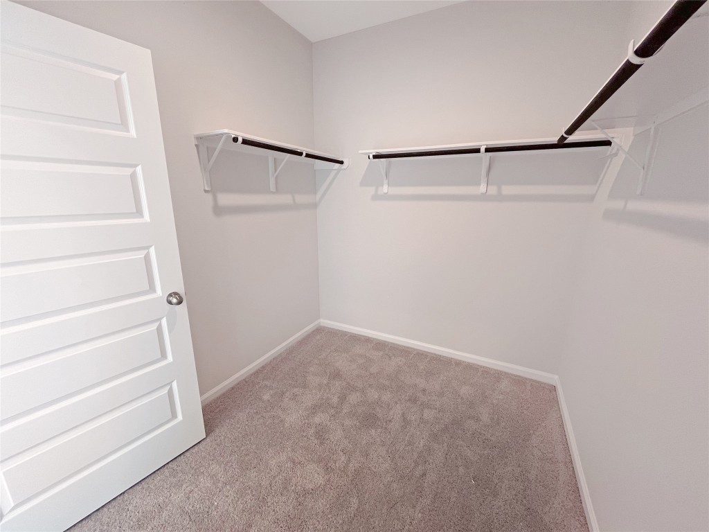 9710 Enclave Ridge Road Willis, TX 77318 - Photo 15 of 24 The Georgetown II- Primary Walk-in Closet. Sample image for illustration; upgrades, options, and colors may vary.