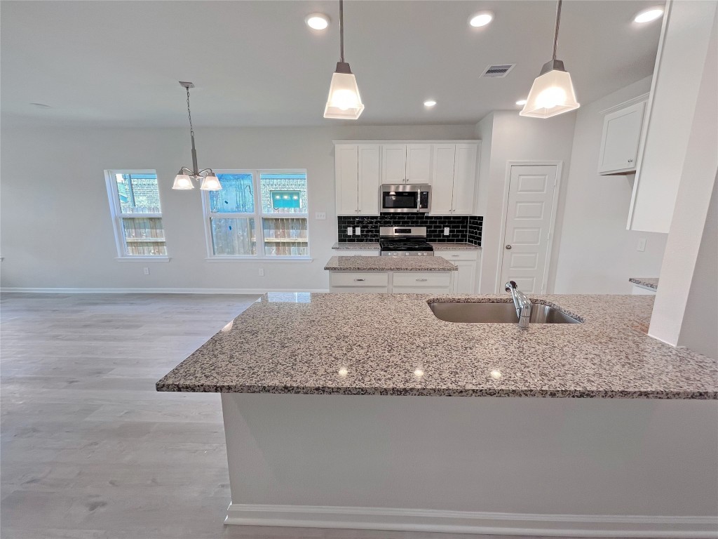 9710 Enclave Ridge Road Willis, TX 77318 - Photo 4 of 24 The Georgetown II- Foyer into Kitchen. Sample image for illustration; upgrades, options, and colors may vary.