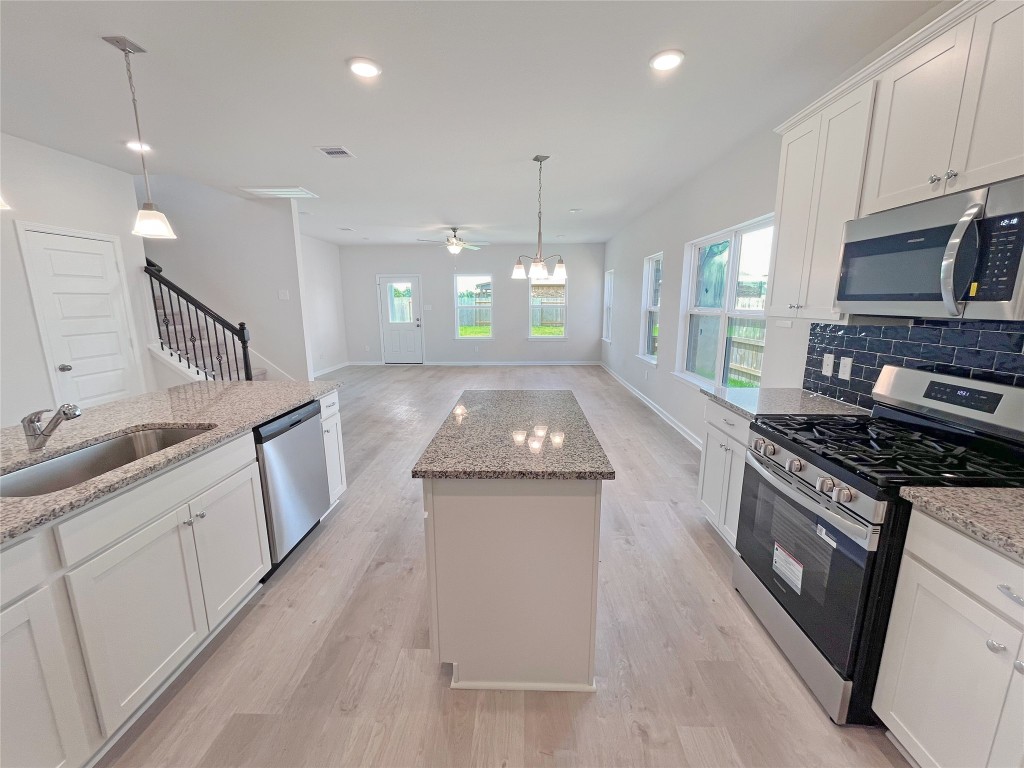 9710 Enclave Ridge Road Willis, TX 77318 - Photo 6 of 24 The Georgetown II- Kitchen into Family Room.Sample image for illustration; upgrades, options, and colors may vary.