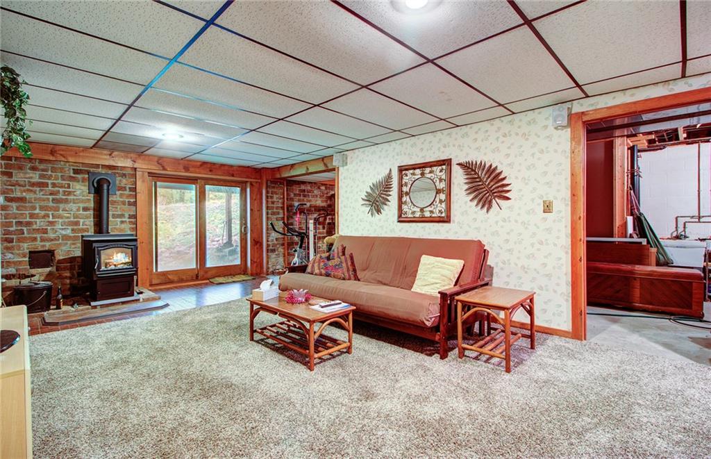 381 Branchton Road Slippery Rock, PA 16057 - Photo 17 of 25 This is the game room 23x14 on lower level. New pellet stove 2019 easy outside access. On the right is utility room with water softner/ hot water tank/ furnace in its own separate room. Great storage area too.