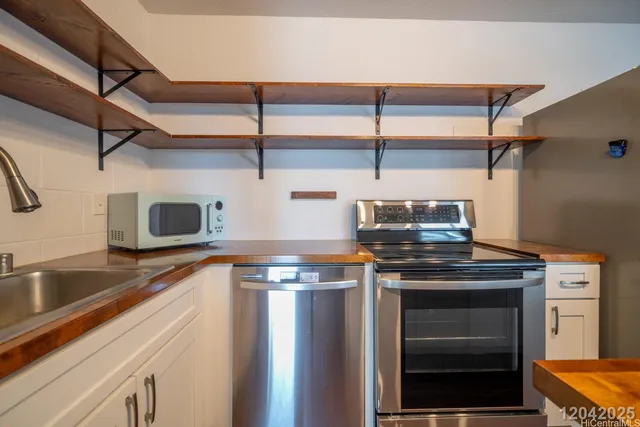 a kitchen with stainless steel appliances granite countertop a stove and a sink