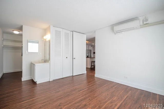 a view of an empty room with wooden floor