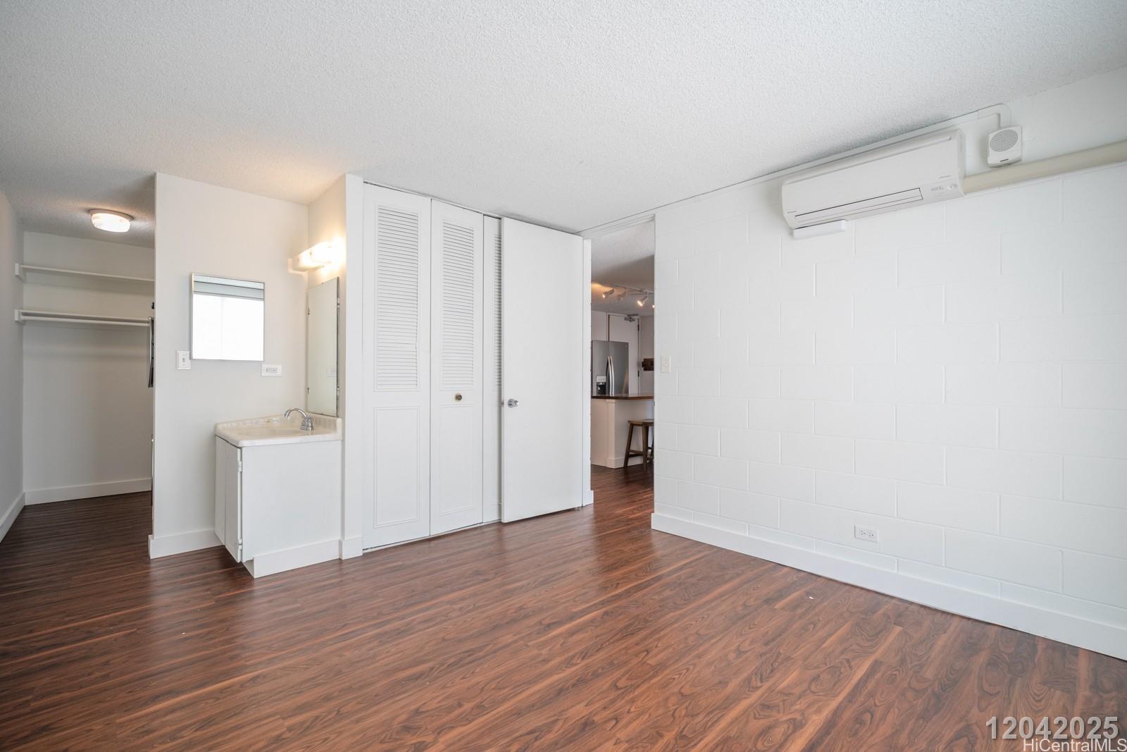 1415 Punahou Street, Unit 306 Honolulu, HI 96822 - Photo 17 of 19 a view of an empty room with wooden floor