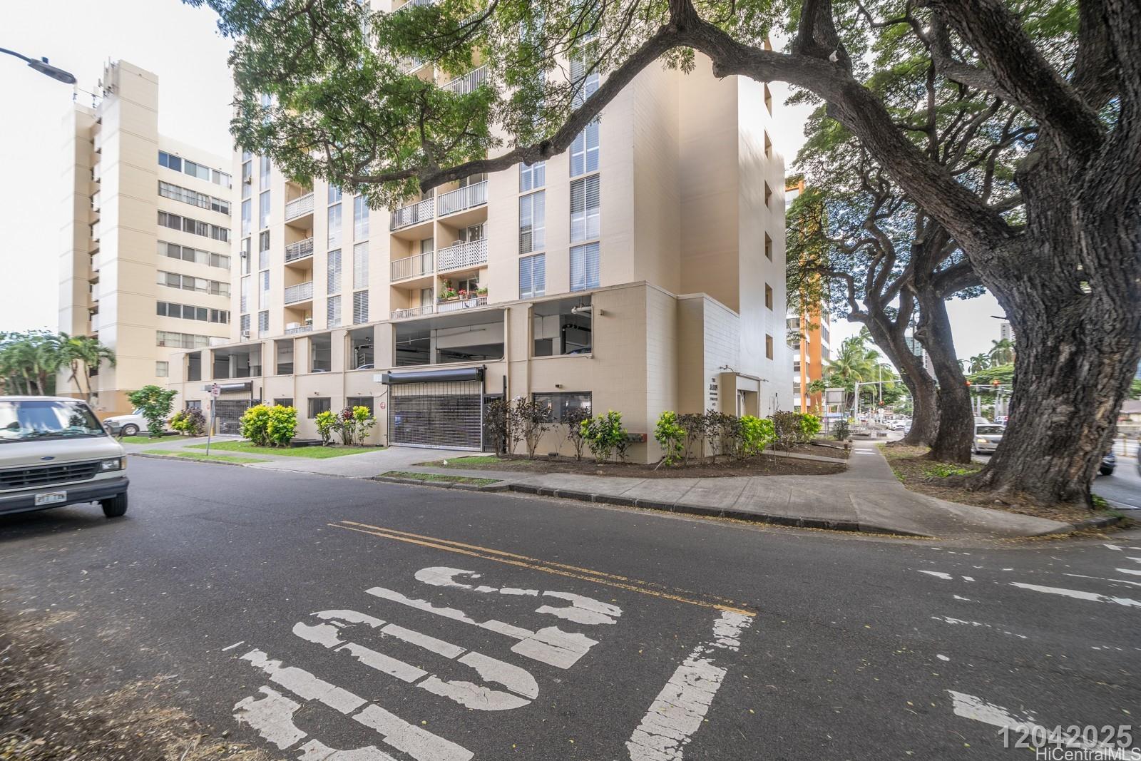 1415 Punahou Street, Unit 306 Honolulu, HI 96822 - Photo 2 of 19 a city street lined with buildings and trees