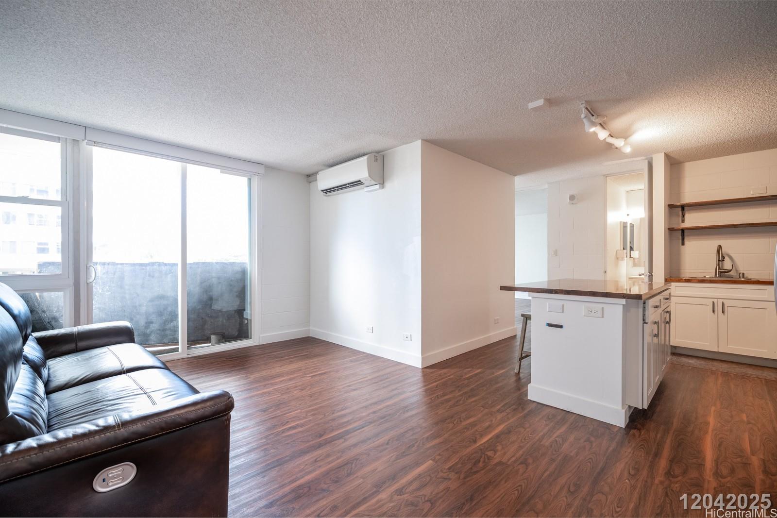 1415 Punahou Street, Unit 306 Honolulu, HI 96822 - Photo 4 of 19 a kitchen with a refrigerator and a stove top oven