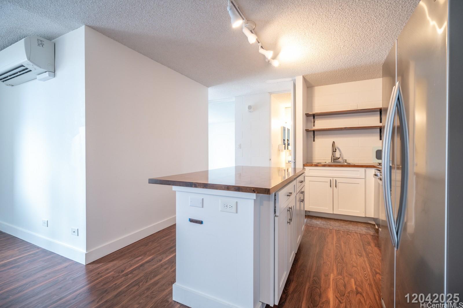 1415 Punahou Street, Unit 306 Honolulu, HI 96822 - Photo 8 of 19 a kitchen with a sink and wooden floor