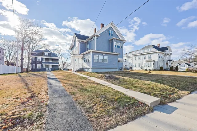 a view of large house with a yard