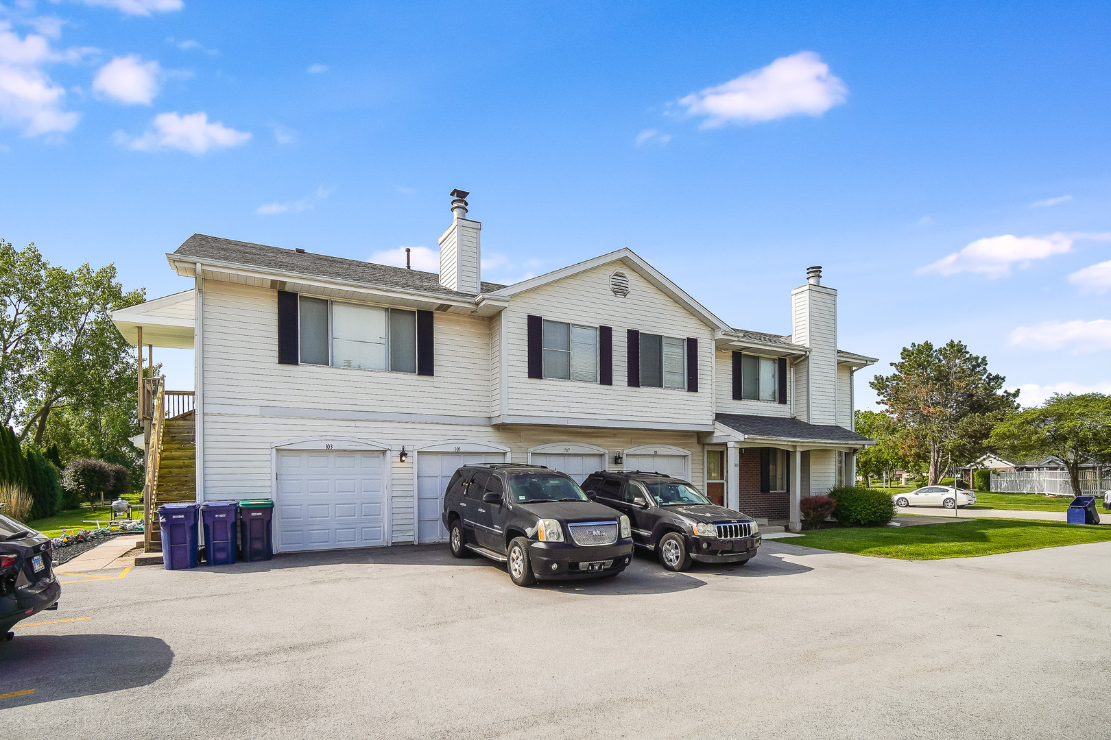 a view of a house with a patio and a yard