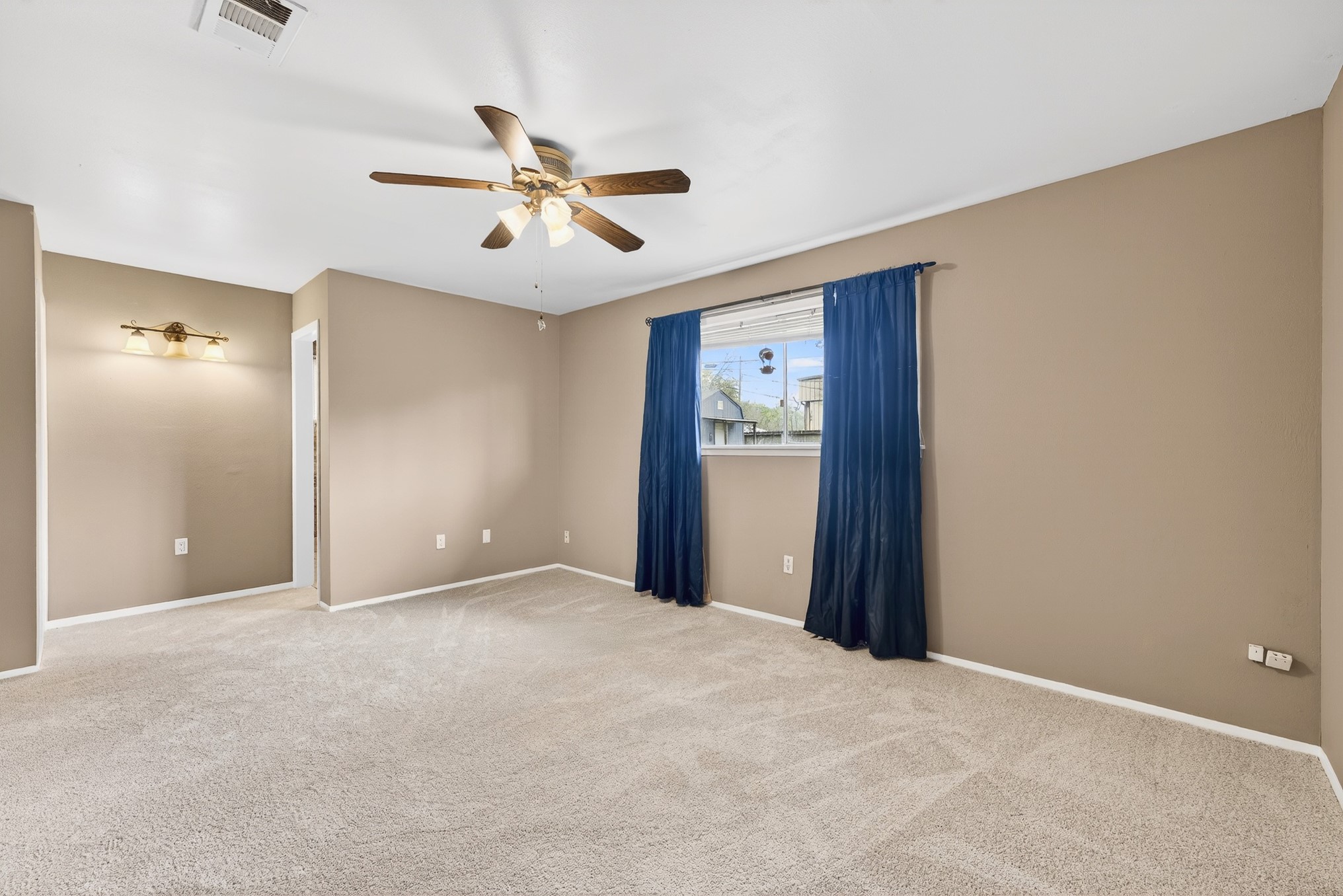 304 Fullen Street Conroe, TX 77301 - Photo 13 of 25 Another view of the primary bedroom, showing multiple options for arranging furniture.