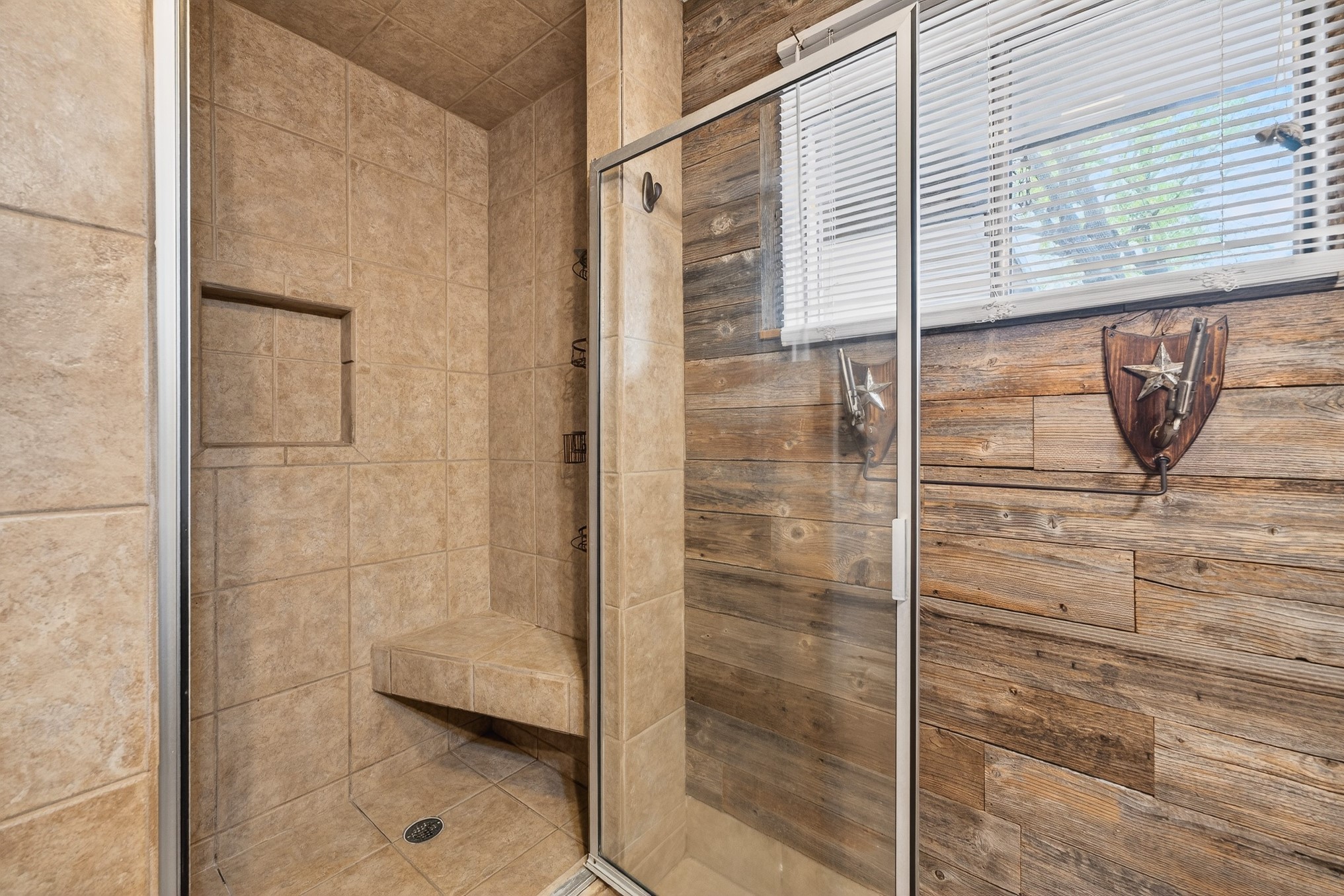 304 Fullen Street Conroe, TX 77301 - Photo 17 of 25 Primary bath features a completely tiled walk-in shower with bench and glass door.
