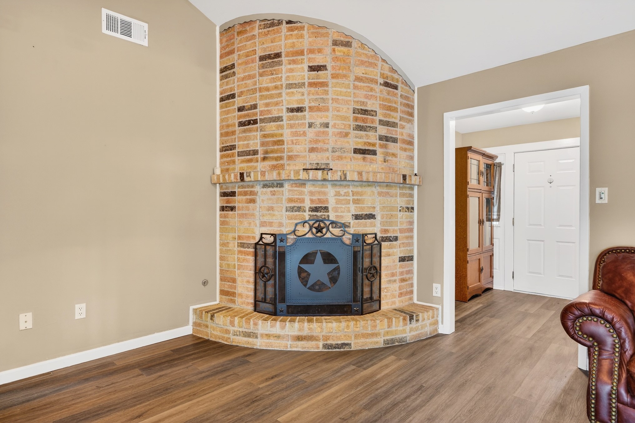 304 Fullen Street Conroe, TX 77301 - Photo 5 of 25 The family room is made cozy by the brick fireplace, a beautiful focal point.