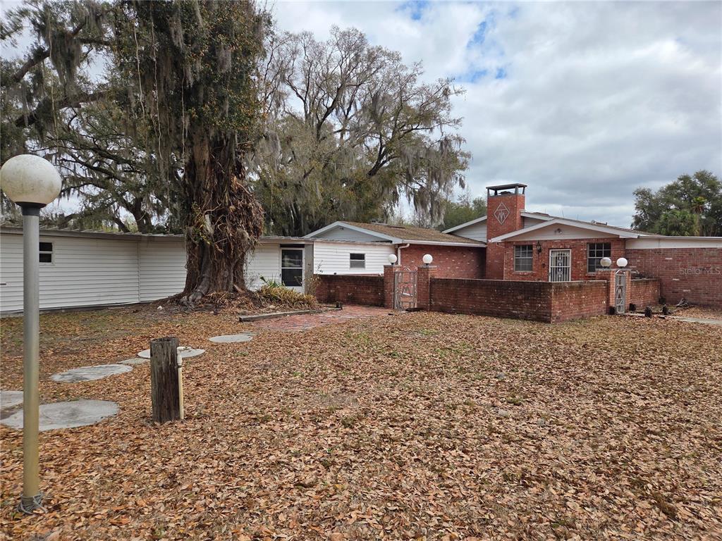 4911 West Sam Allen Road Plant City, FL 33565 - Photo 2 of 11 a front view of a house with a yard