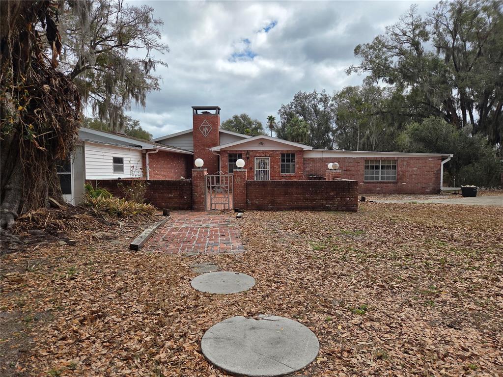 4911 West Sam Allen Road Plant City, FL 33565 - Photo 3 of 11 a front view of a house with garden