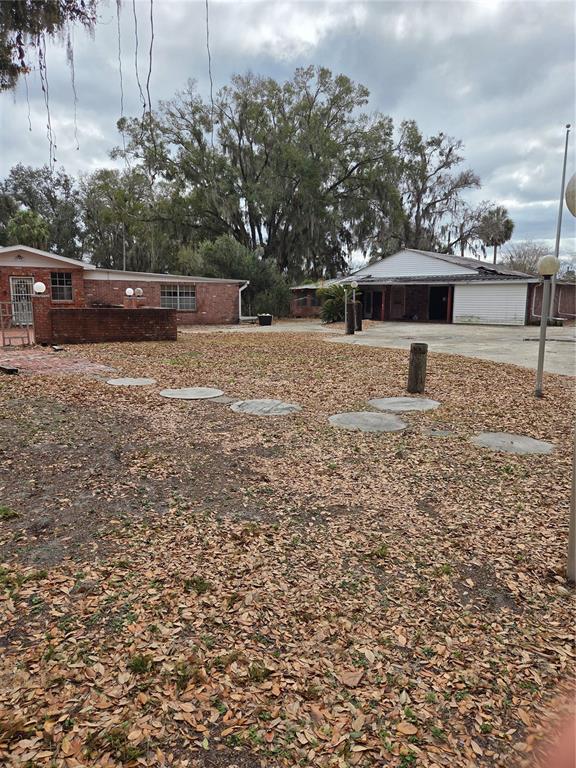 4911 West Sam Allen Road Plant City, FL 33565 - Photo 9 of 11 a front view of a house with a yard