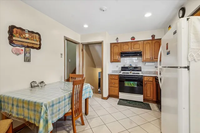 a kitchen with stainless steel appliances a stove a sink and a refrigerator