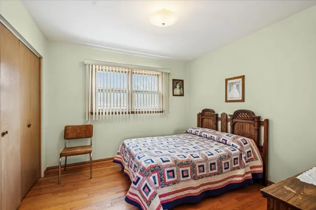 a bedroom with a bed and a chair