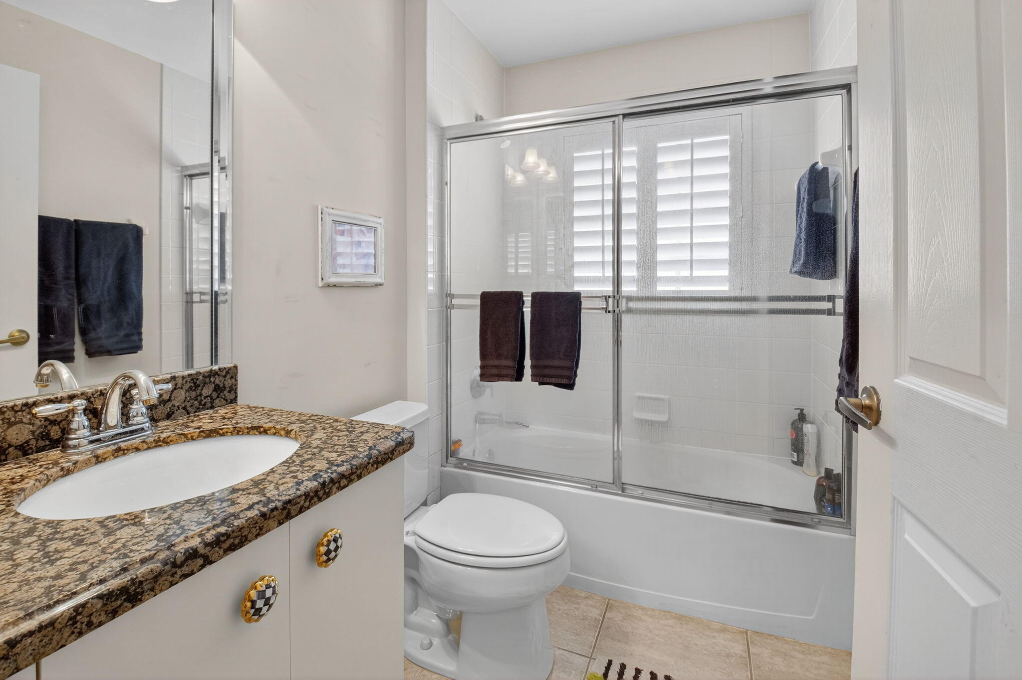 6129 Petunia Road Delray Beach, FL 33484 - Photo 28 of 73 a bathroom with a granite countertop sink toilet and shower