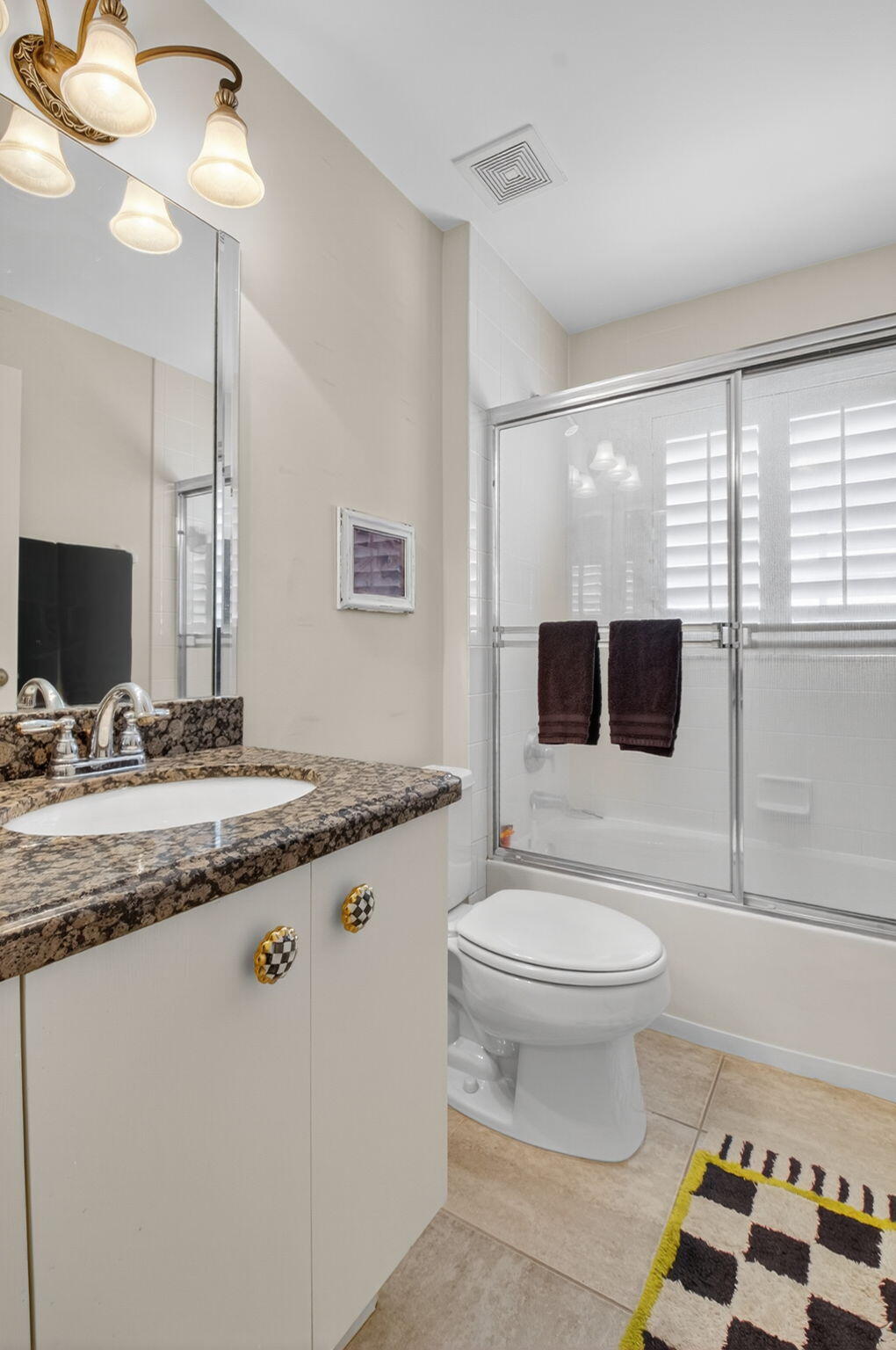 6129 Petunia Road Delray Beach, FL 33484 - Photo 29 of 73 a bathroom with a toilet a sink and a mirror
