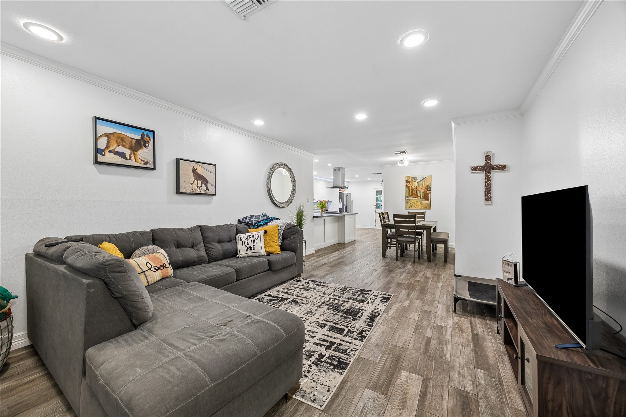 5526 Grape Street Houston, TX 77096 - Photo 2 of 10 a living room with furniture and a flat screen tv
