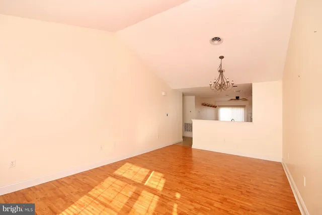 a view of a room with a sink and wooden floor