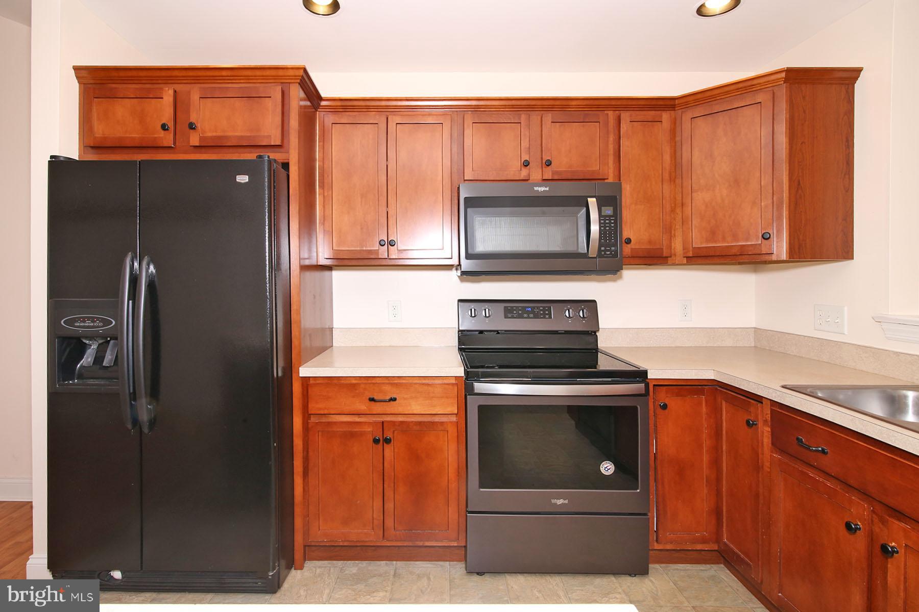 43 Farm Lane Lancaster, PA 17603 - Photo 21 of 42 a kitchen with stainless steel appliances granite countertop a refrigerator stove and microwave