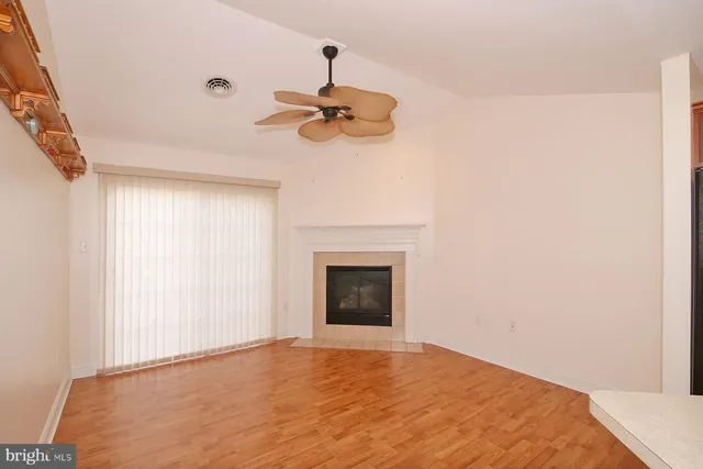 a view of an empty room with a fireplace