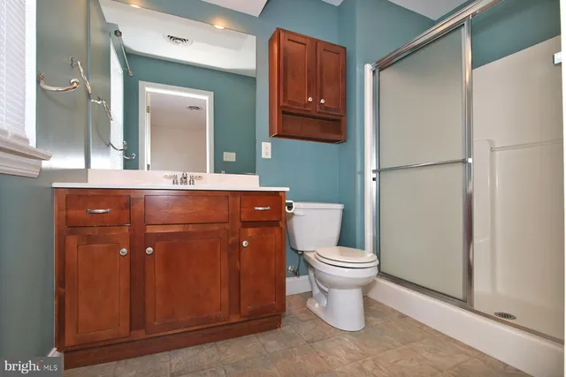 a bathroom with a toilet a sink and a mirror