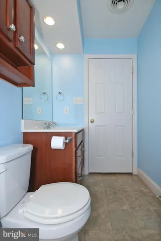 a bathroom with a toilet a sink and mirror