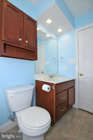 a bathroom with a toilet sink and mirror