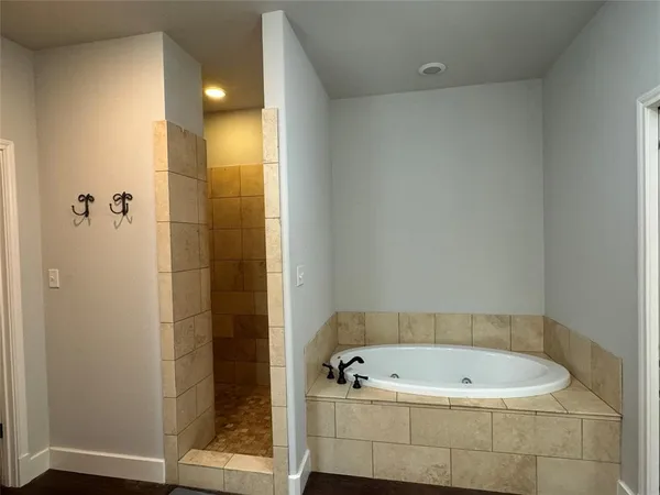 a room with wooden floor and ceiling fan