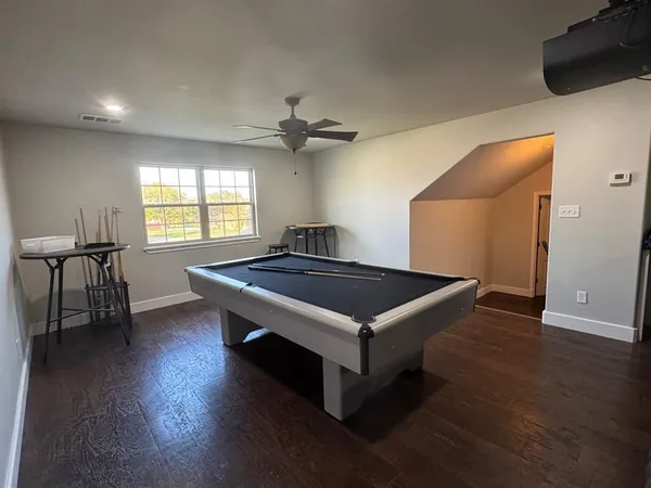 an empty room with wooden floor and a window