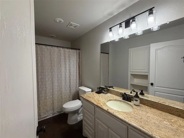 a bed room with a bed and a television