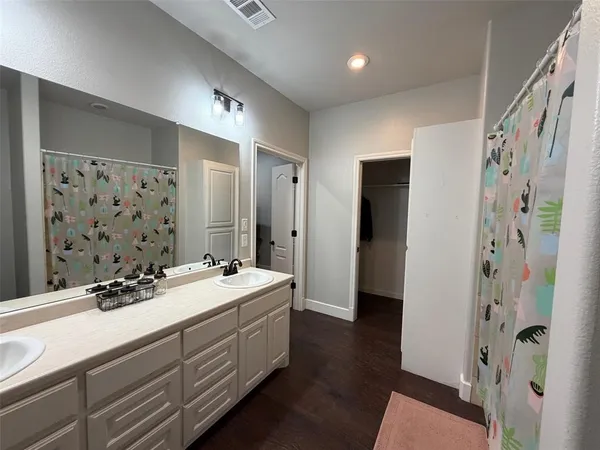a white toilet sitting next to a window in a bathroom