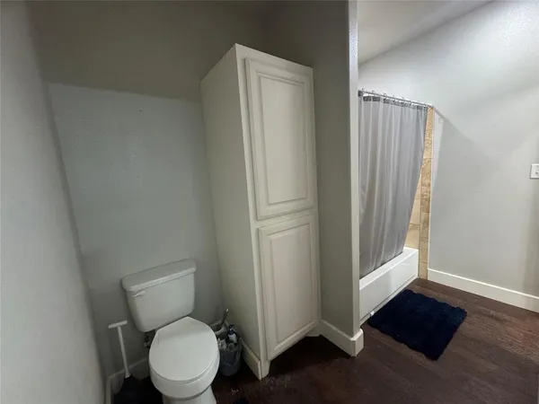 a hallway with a white car parked in a kitchen