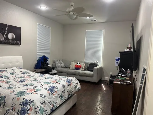 a view of a hallway with wooden floor and cabinets
