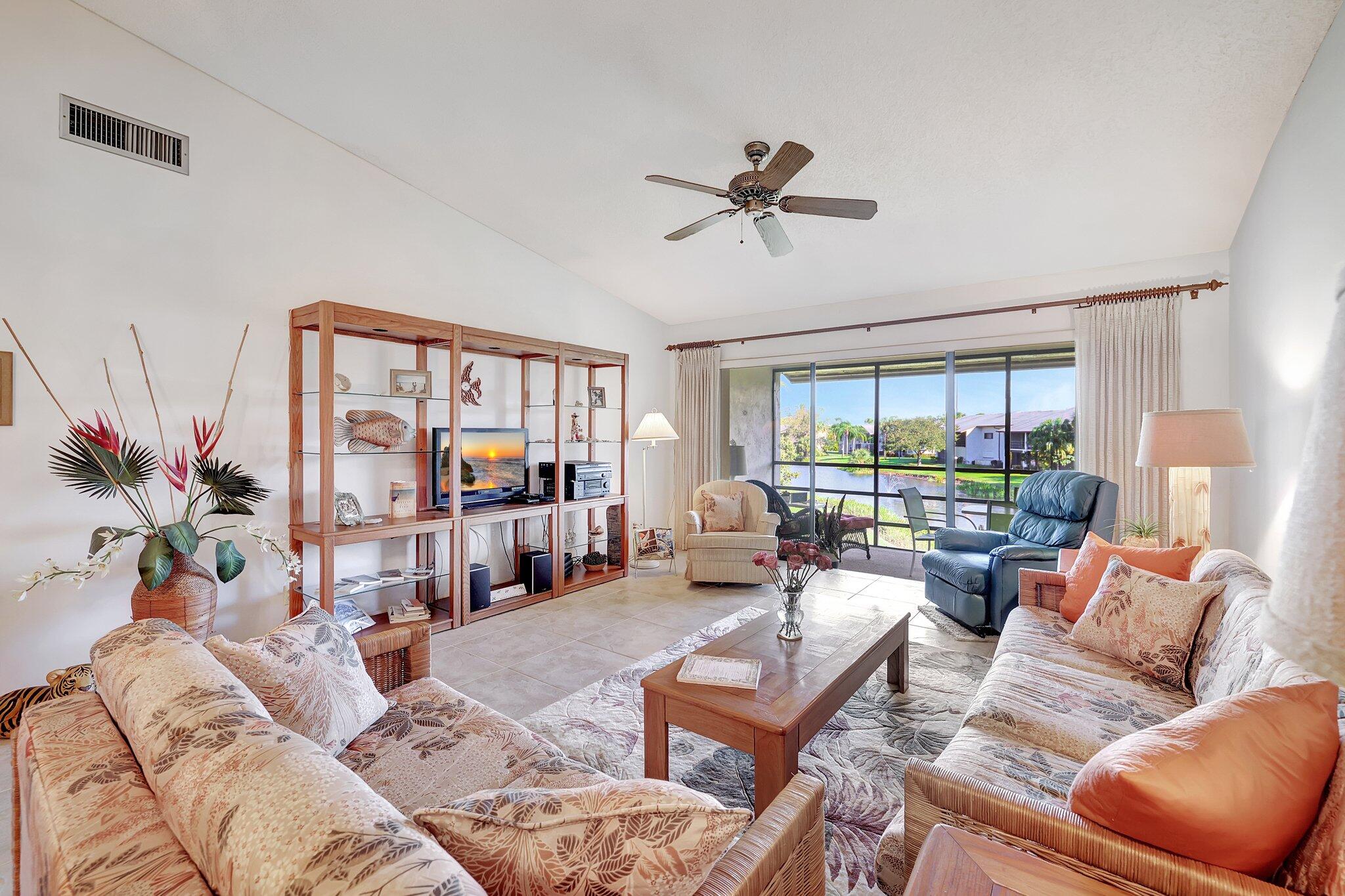 3001 Southeast Aster Lane, Unit 906 Stuart, FL 34994 - Photo 11 of 24 a living room with furniture and a large window