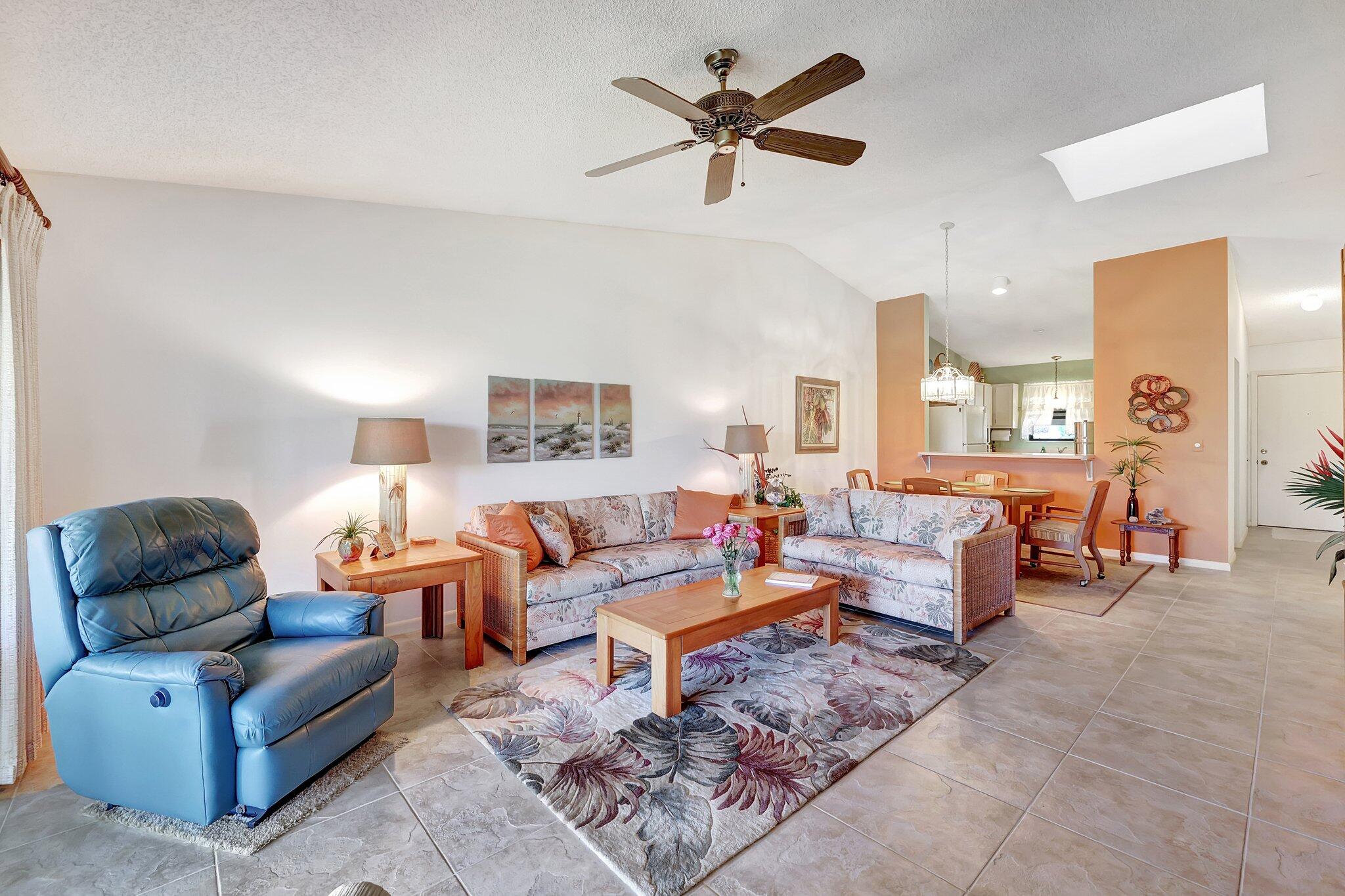 3001 Southeast Aster Lane, Unit 906 Stuart, FL 34994 - Photo 12 of 24 a living room with furniture or couch and a lamp