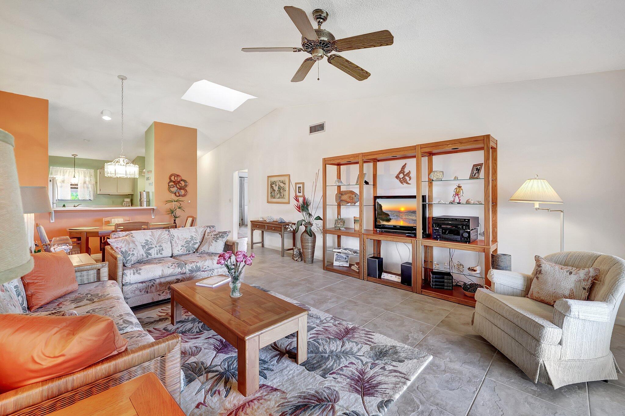 3001 Southeast Aster Lane, Unit 906 Stuart, FL 34994 - Photo 13 of 24 a living room with furniture a rug and a large window