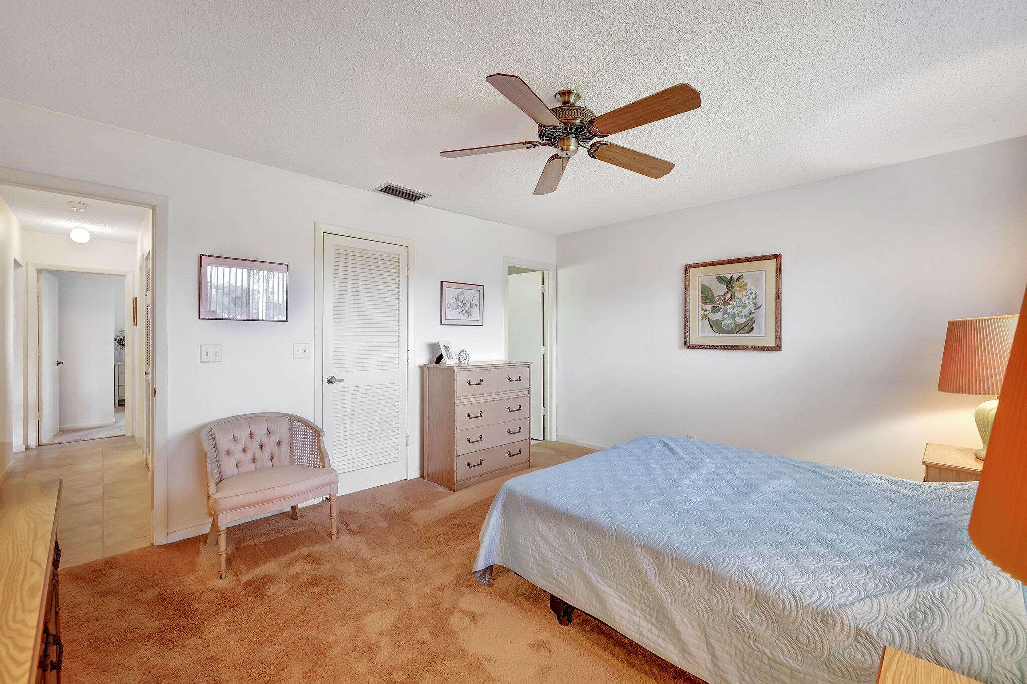 3001 Southeast Aster Lane, Unit 906 Stuart, FL 34994 - Photo 15 of 24 a bedroom with a bed and a cabinets