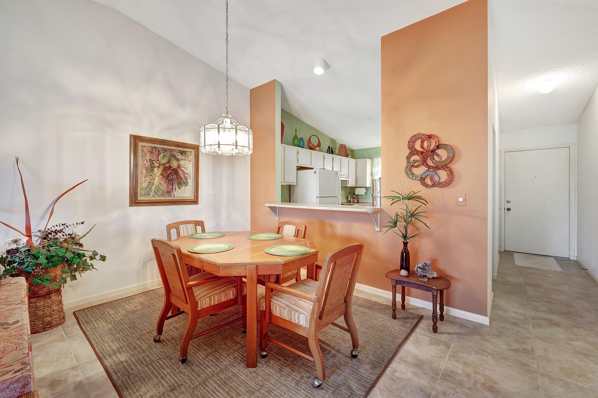 3001 Southeast Aster Lane, Unit 906 Stuart, FL 34994 - Photo 5 of 24 a view of a dining room with furniture and a potted plant