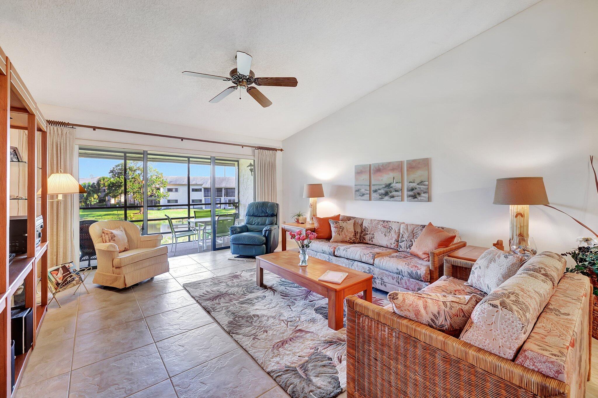 3001 Southeast Aster Lane, Unit 906 Stuart, FL 34994 - Photo 10 of 24 a living room with furniture and a large window
