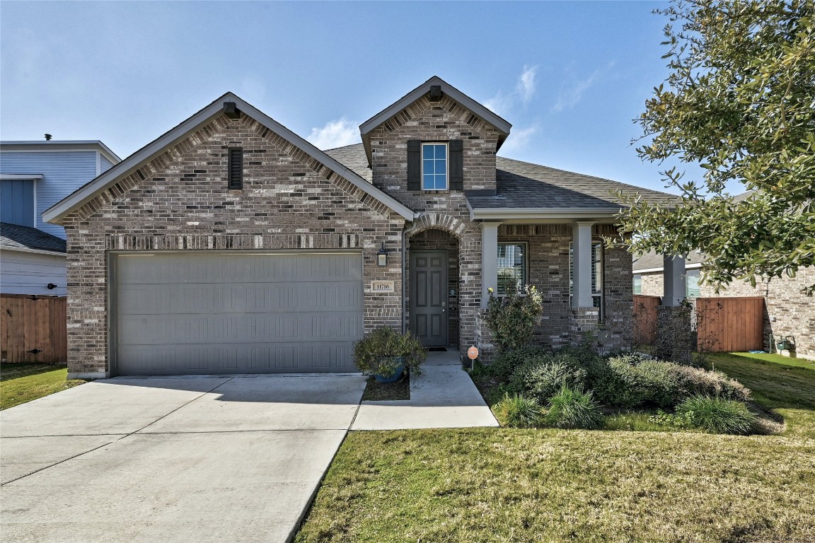 11716 American Mustang Loop Manor, TX 78653 - Photo 1 of 1 a front view of a house with garden