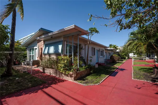 a front view of a house with yard and green space