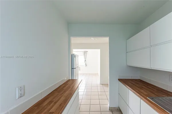 a hallway with a sink and cabinets