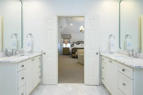 a en suite bathroom with a granite countertop sink and a mirror