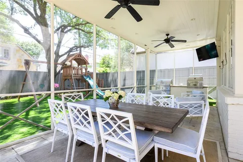 a dining room with furniture and a floor to ceiling window